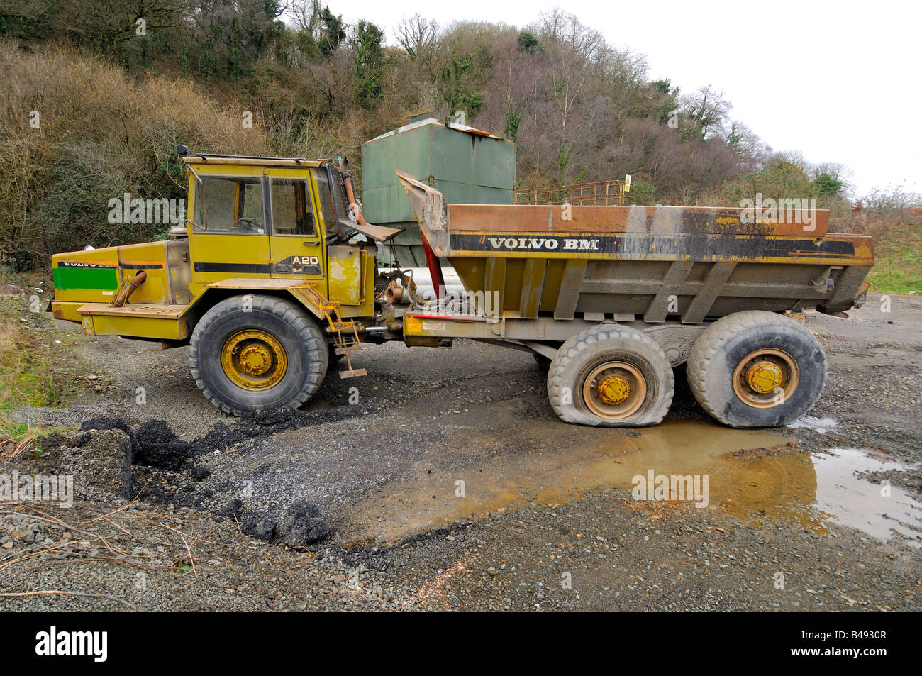 An abandoned Volvo BM A20 dump truck left to rust in a forgotten corner of a quarry Stock Photo