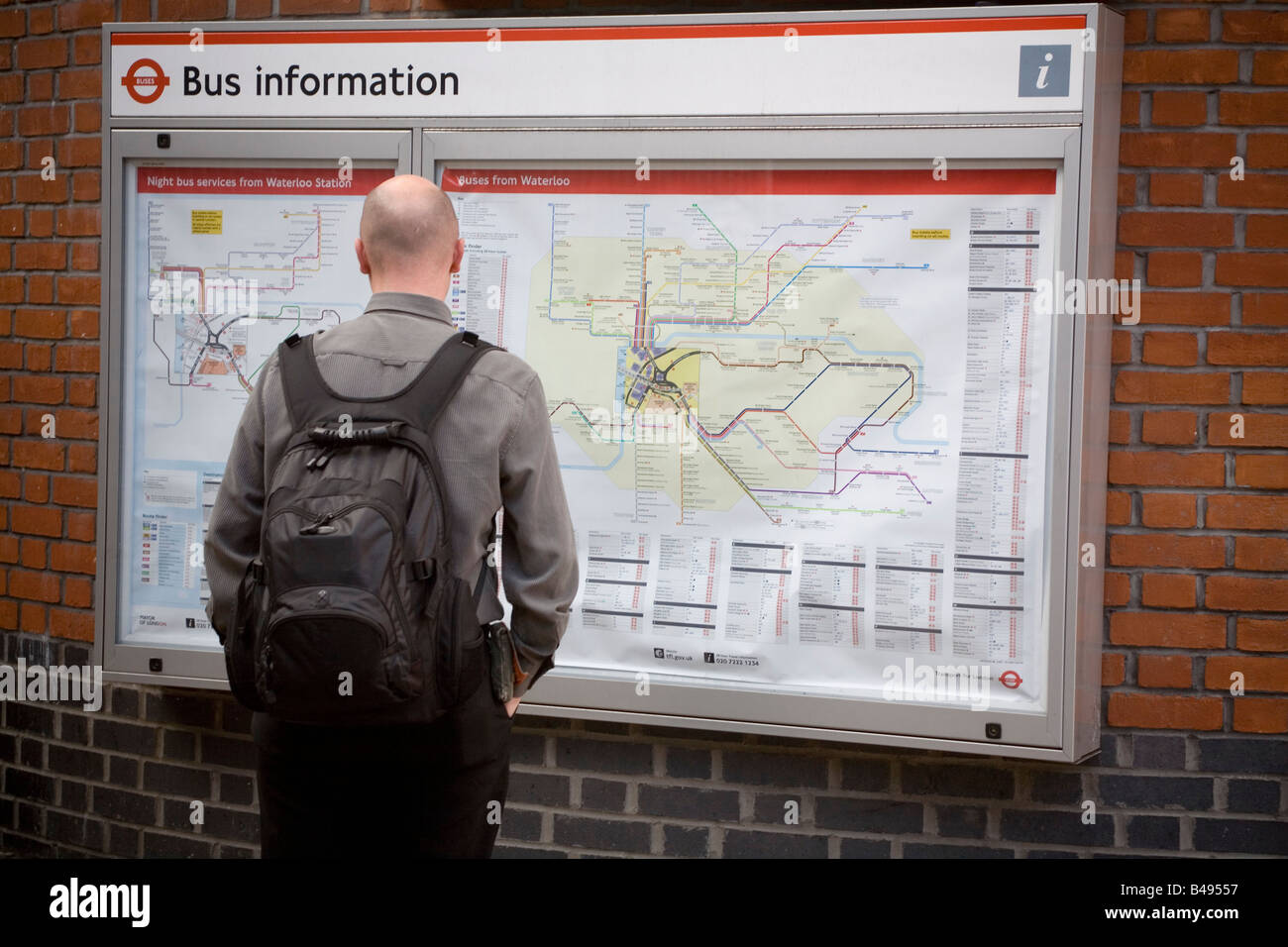 Man looking at a London's public transport map England Britain UK Stock Photo