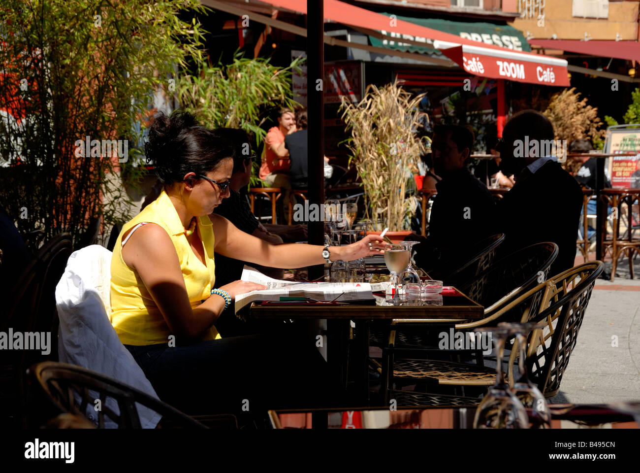 Stock Photo Of A Woman Sitting Outside A French Cafe In The City Of Limoges Smoking A Cigarette 