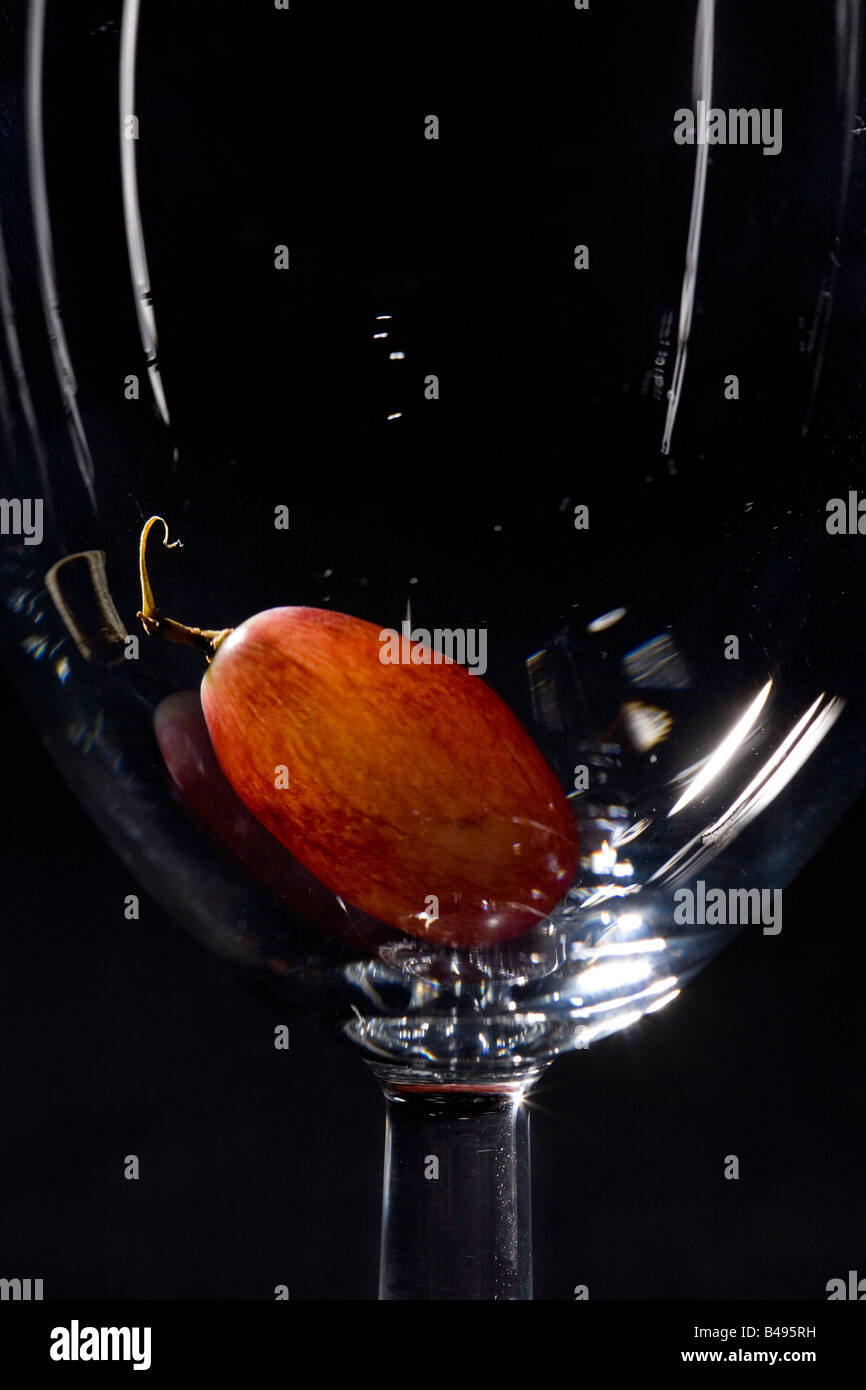 A red grape in a wine glass Stock Photo