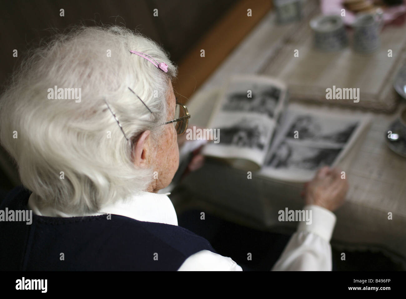 Elderly woman watching photos, Rheinzabern, Germany Stock Photo