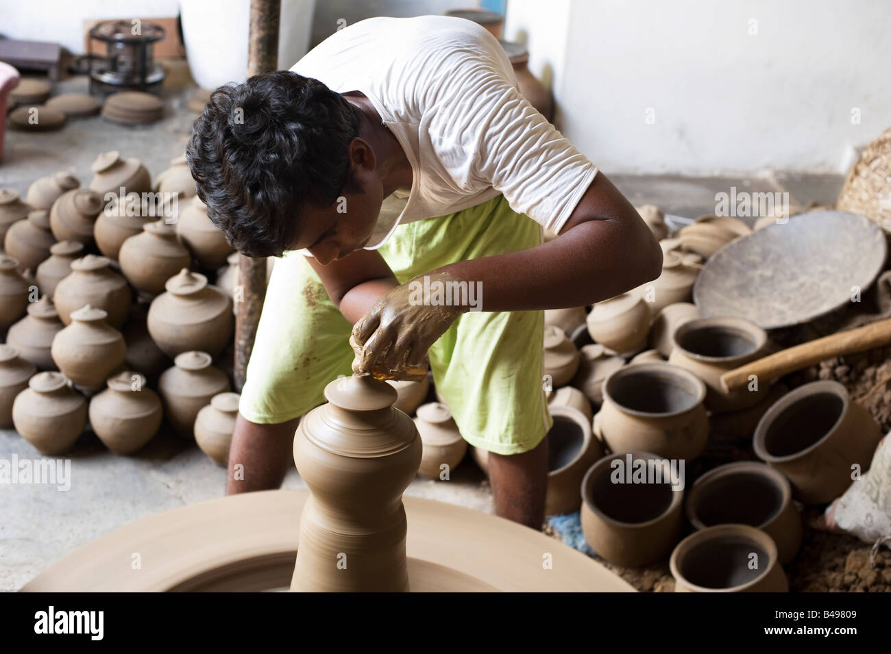 Traditional village Indian potters livelihood, throwing pots out of one