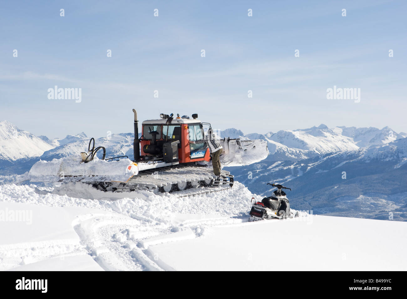 snow cat ploughing snow to build a snowboard jump Stock Photo Alamy