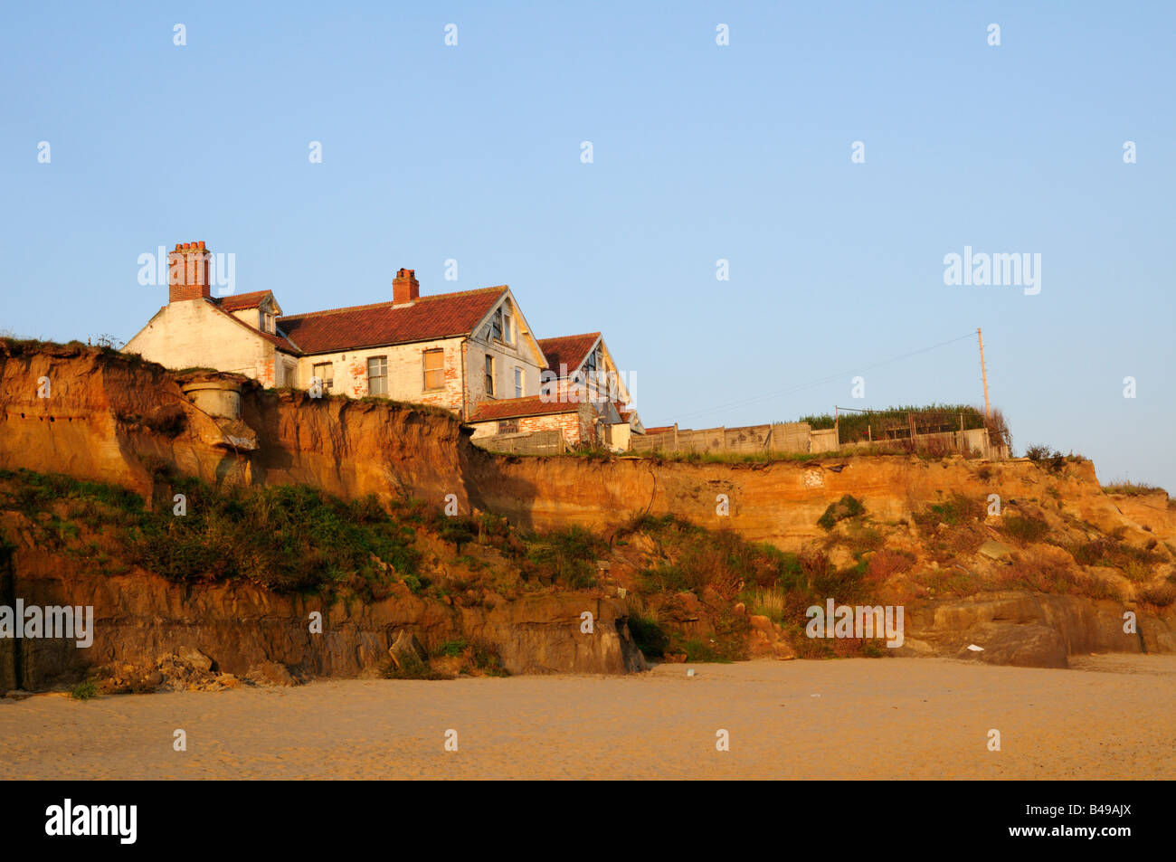 House on the cliff edge, Happisburgh Norfolk England UK Stock Photo