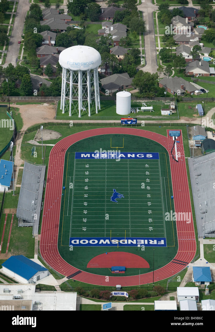 aerial above Friendswood Texas TX water tower and Mustangs football field and track Stock Photo
