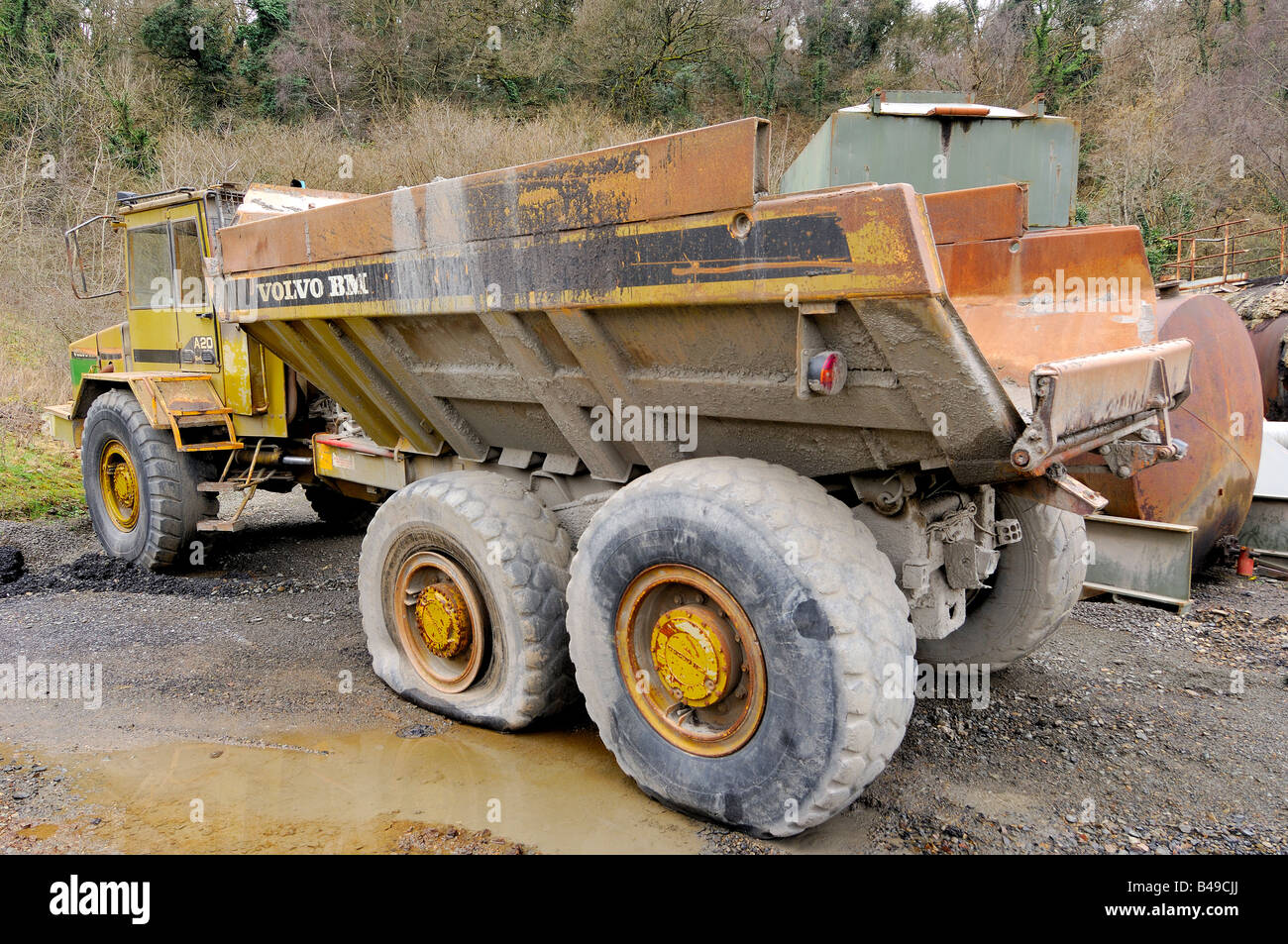 An abandoned Volvo BM A20 dump truck left to rust in a forgotten corner of a quarry Stock Photo