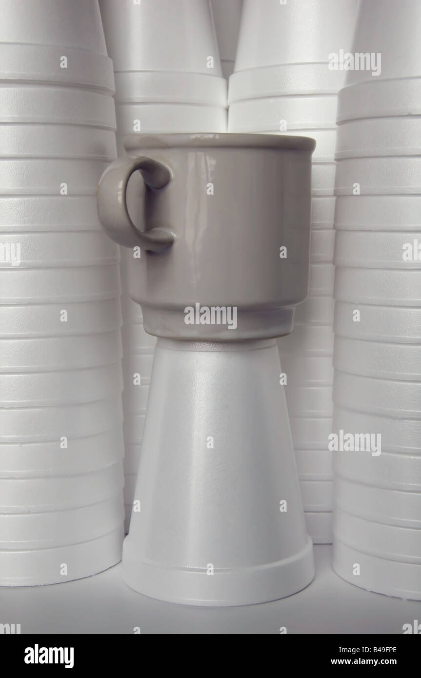 Reusable versus disposable: Gray ceramic mug among many white styrofoam cups Stock Photo