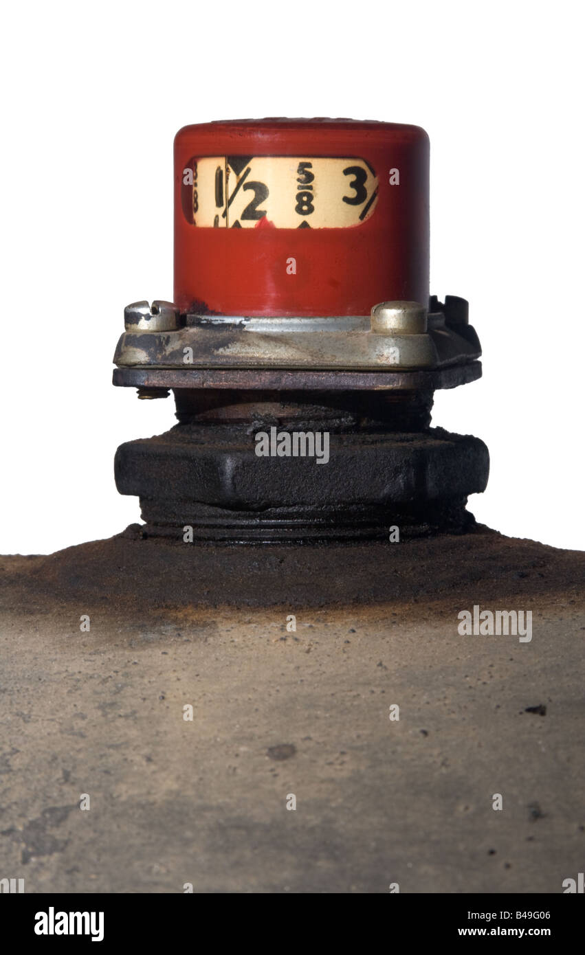 Home heating oil tank and red gauge isolated against white background, vertical composition Stock Photo