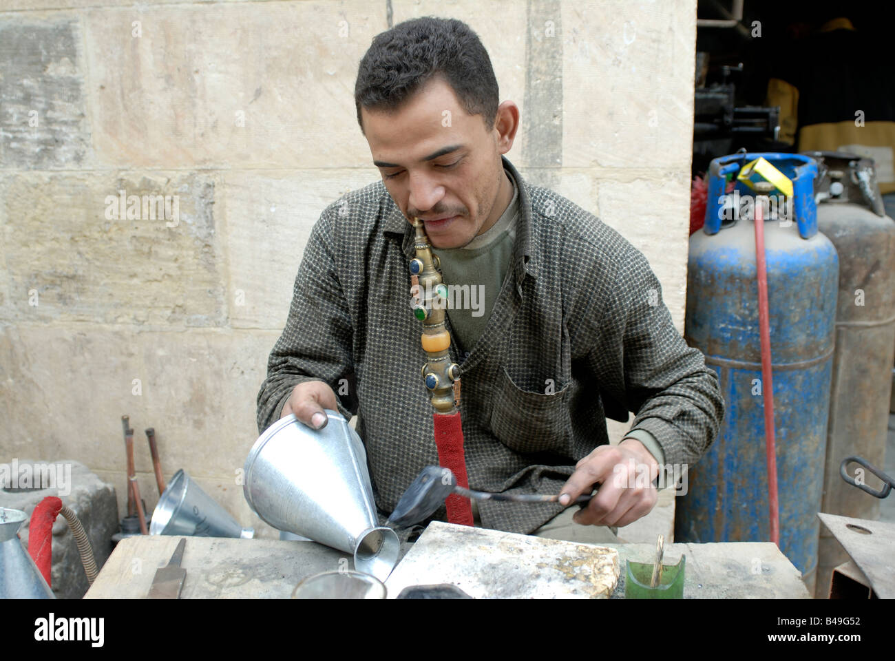 Man smoking a water pipe while working Cairo Egypt Stock Photo Alamy