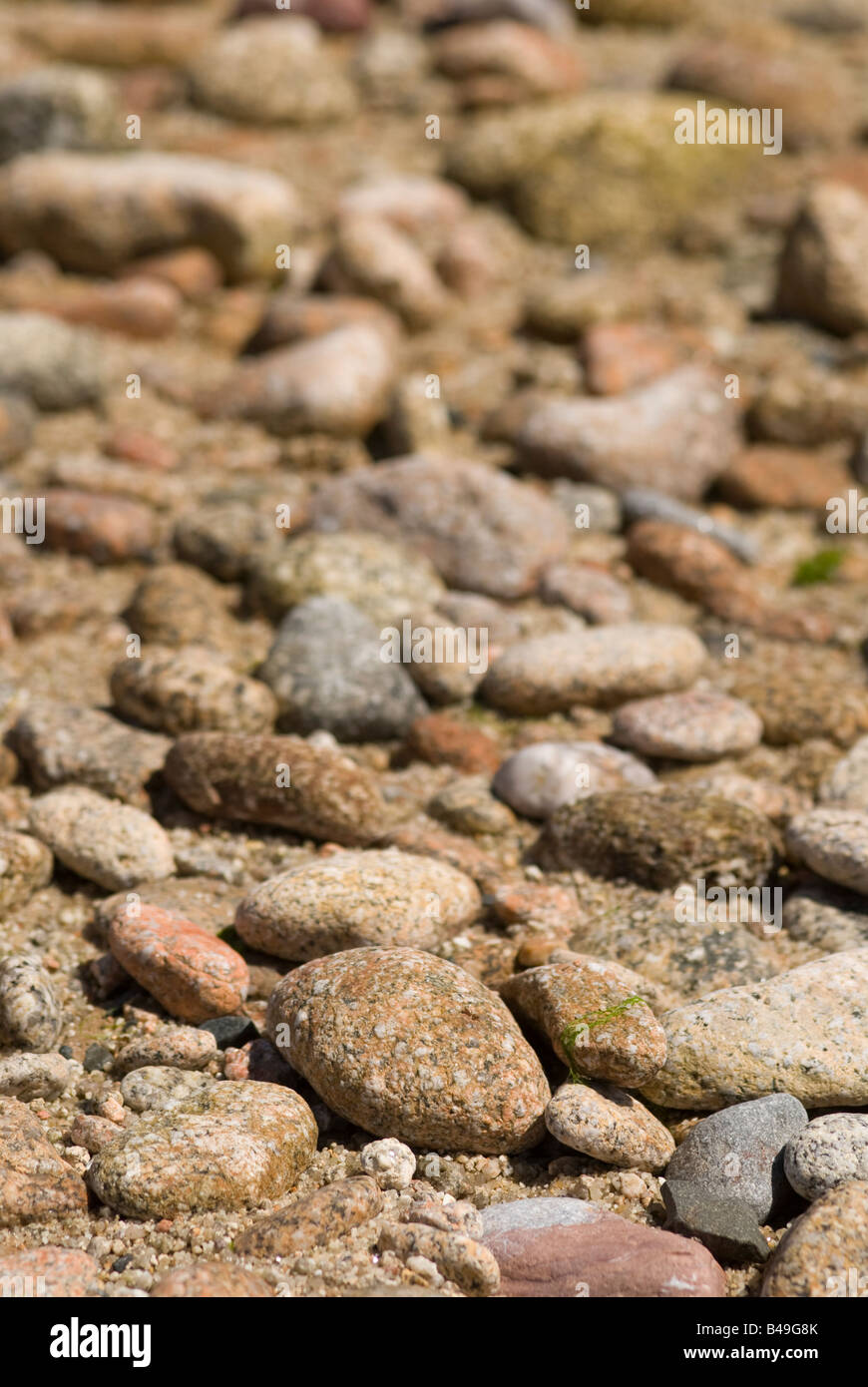 Stones on a beach, gently blurring into the background Stock Photo