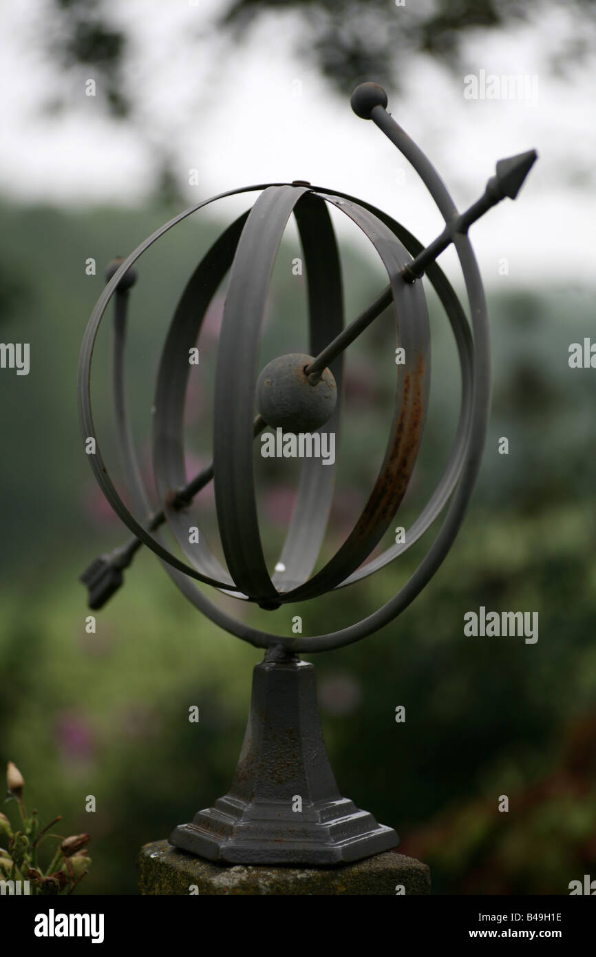 metal garden ornament of an arrow piercing through a sphere Stock Photo