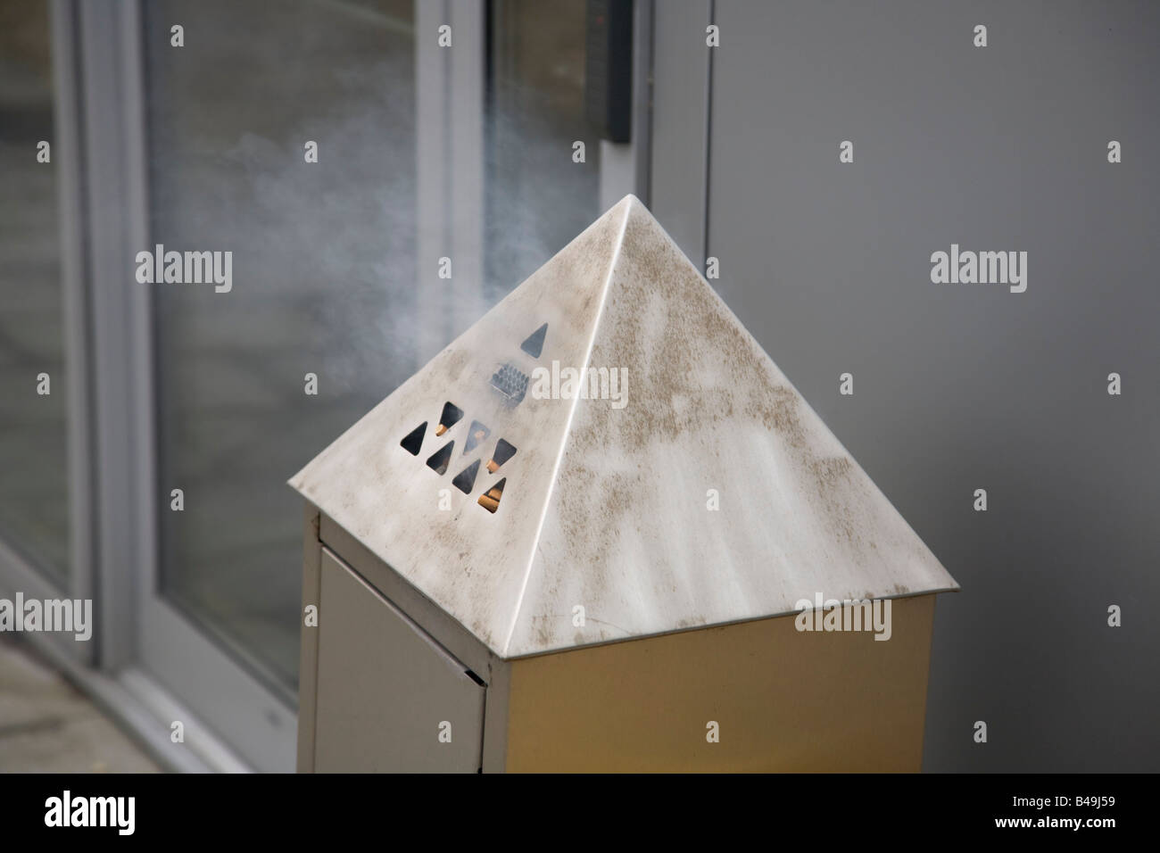 Cigarette smoking area fire in ashtray ash bin outside Stock Photo Alamy