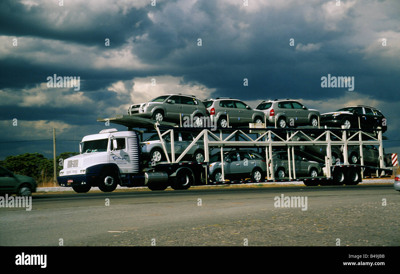 New cars being transported by car hauler in Brazil. Automobile manufacturing is an important industry in Brazil Stock Photo