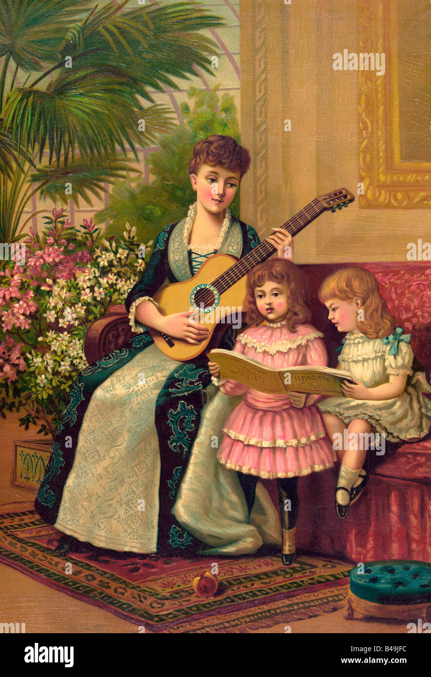 Victorian Era Print showing mother with guitar and two children singing Christmas Carols Stock Photo