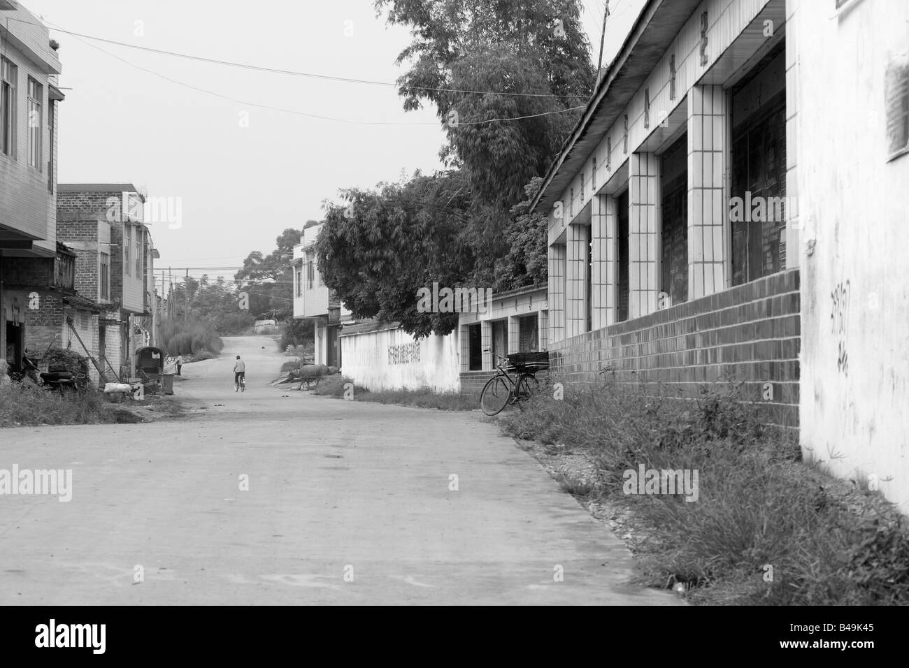 Empty Chinse village street in front of school on school day. As income gap widens it education is a dream that many strive for. Stock Photo