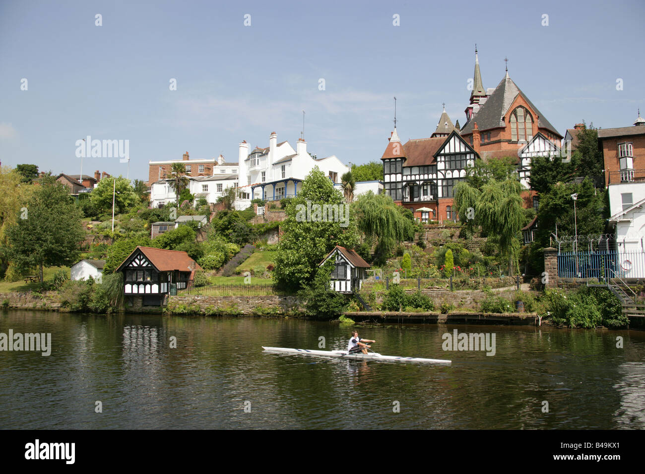 City of Chester, England. Properties on the River Dee at Barrel Well Hill, with St Paul’s Church at Boughton in the background. Stock Photo