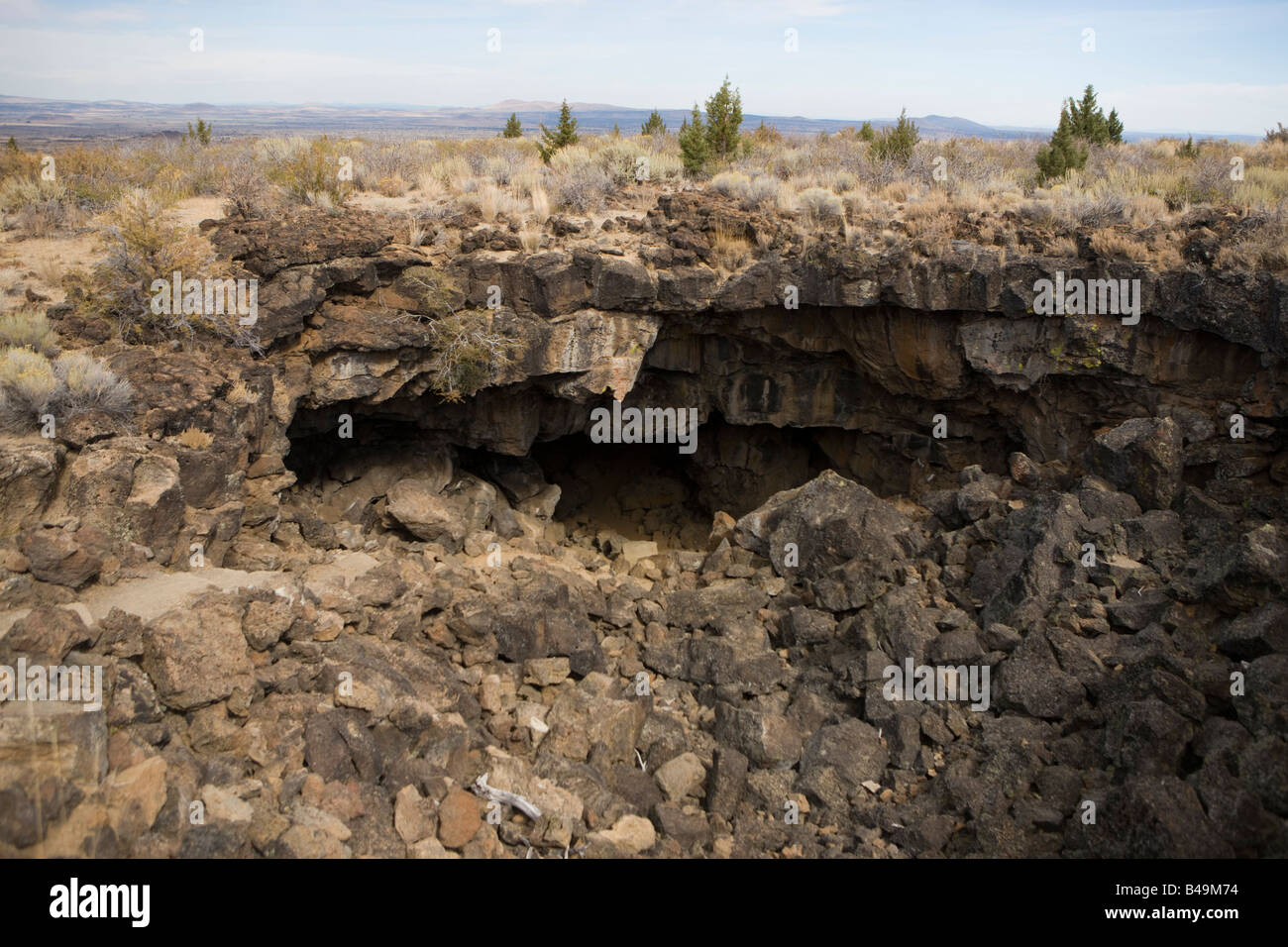 Upper entrance to the Sentinel lava tube cave, Lava Beds National Monument, California Stock