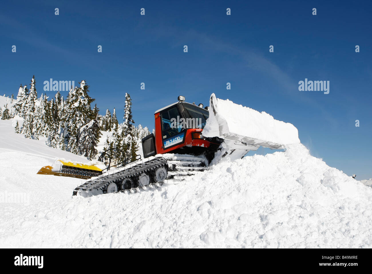snow cat plowing snow to build a snowboard jump Stock Photo Alamy