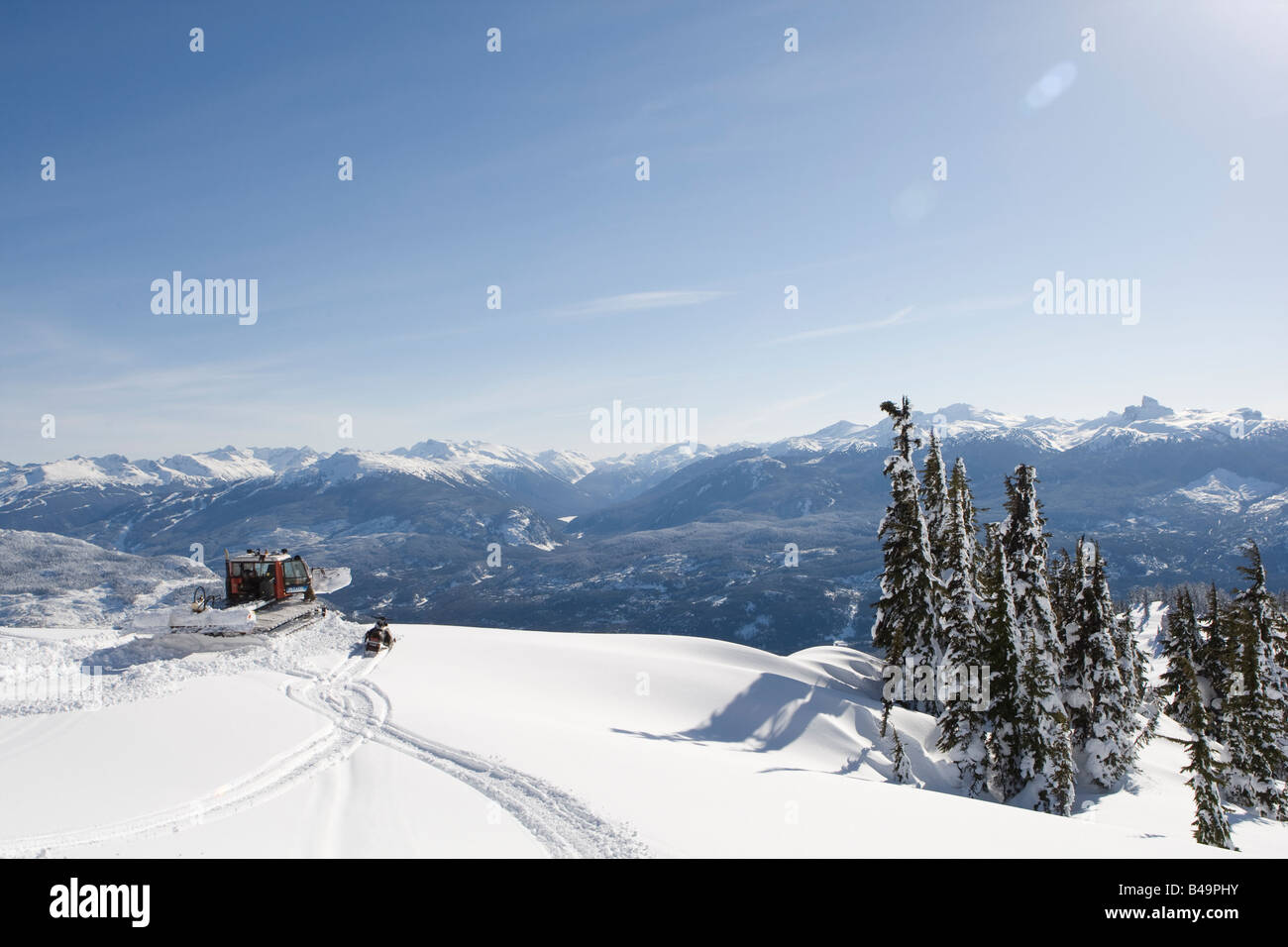 snow cat ploughing snow to build a snowboard jump Stock Photo - Alamy