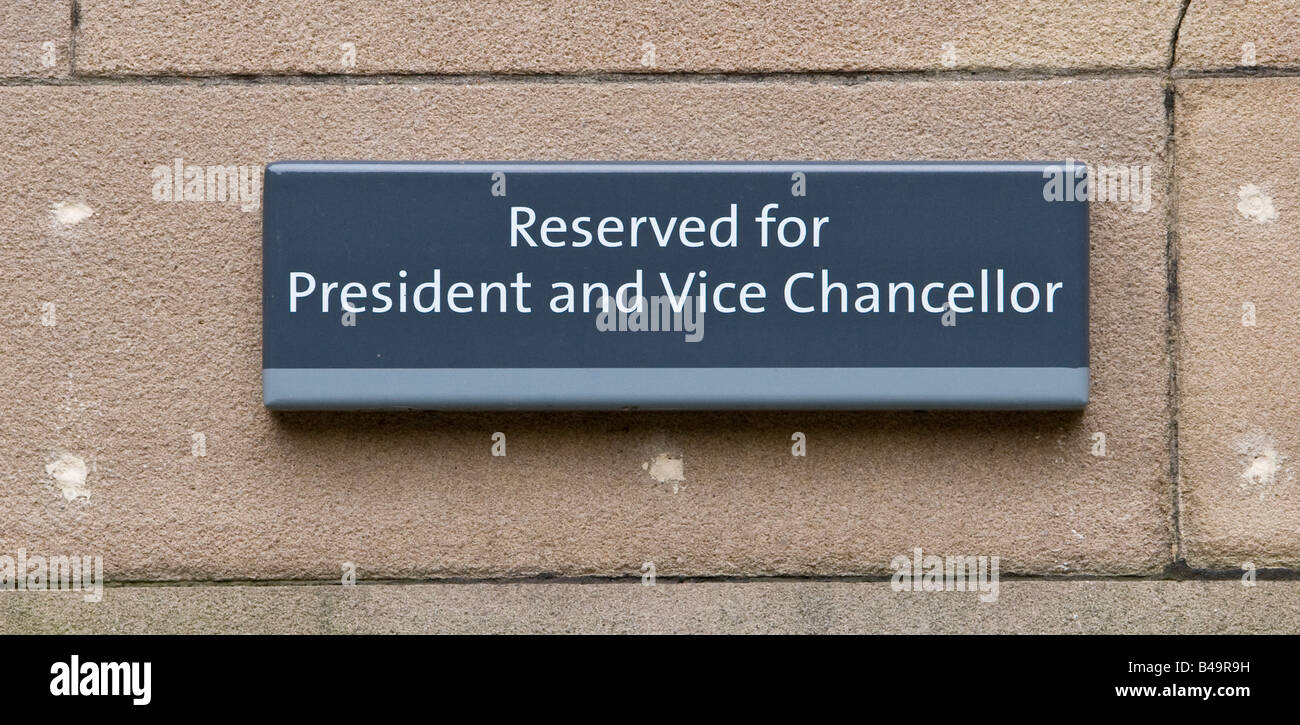 Reserved for President and Vice Chancellor sign on wall of car park in old quadrangle University of Manchester UK Stock Photo