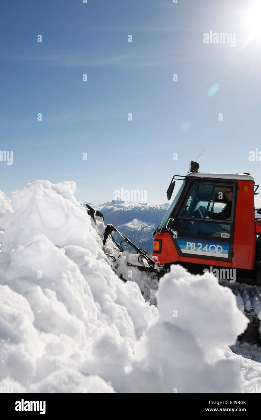snow cat plowing snow to build a snowboard jump Stock Photo Alamy