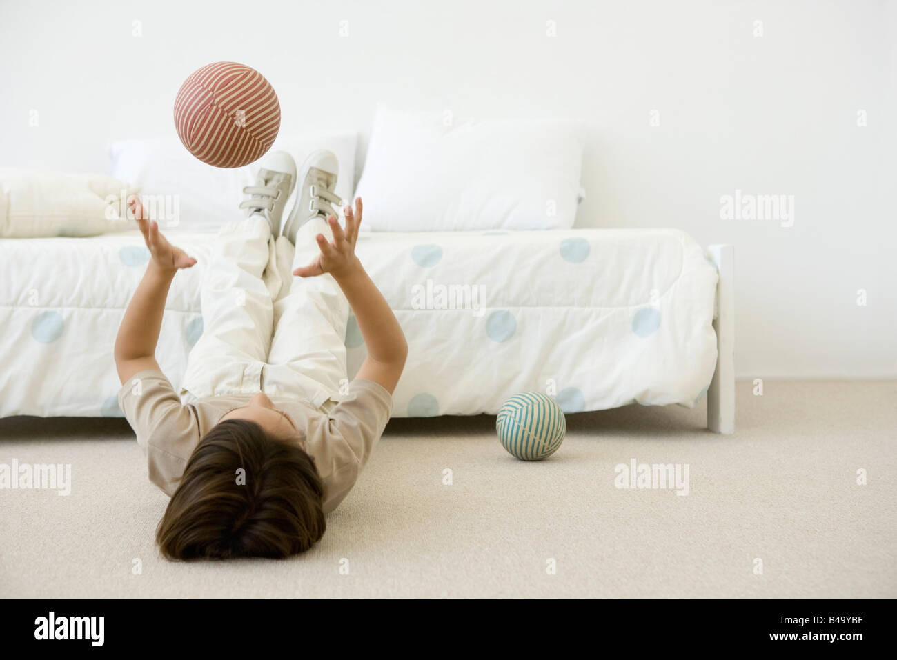 Boy child throws ball up hires stock photography and images Alamy