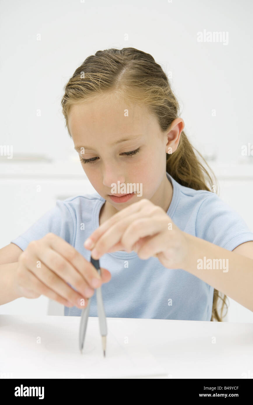 Girl drawing with compass Stock Photo - Alamy