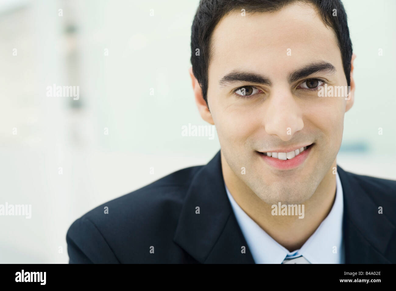 Businessman smiling at camera, portrait Stock Photo - Alamy