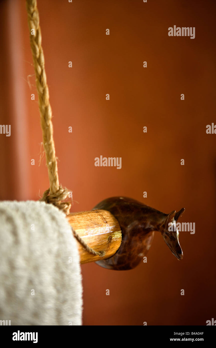 Giraffe towel racks hang from the ceiling in the cottage bathrooms of