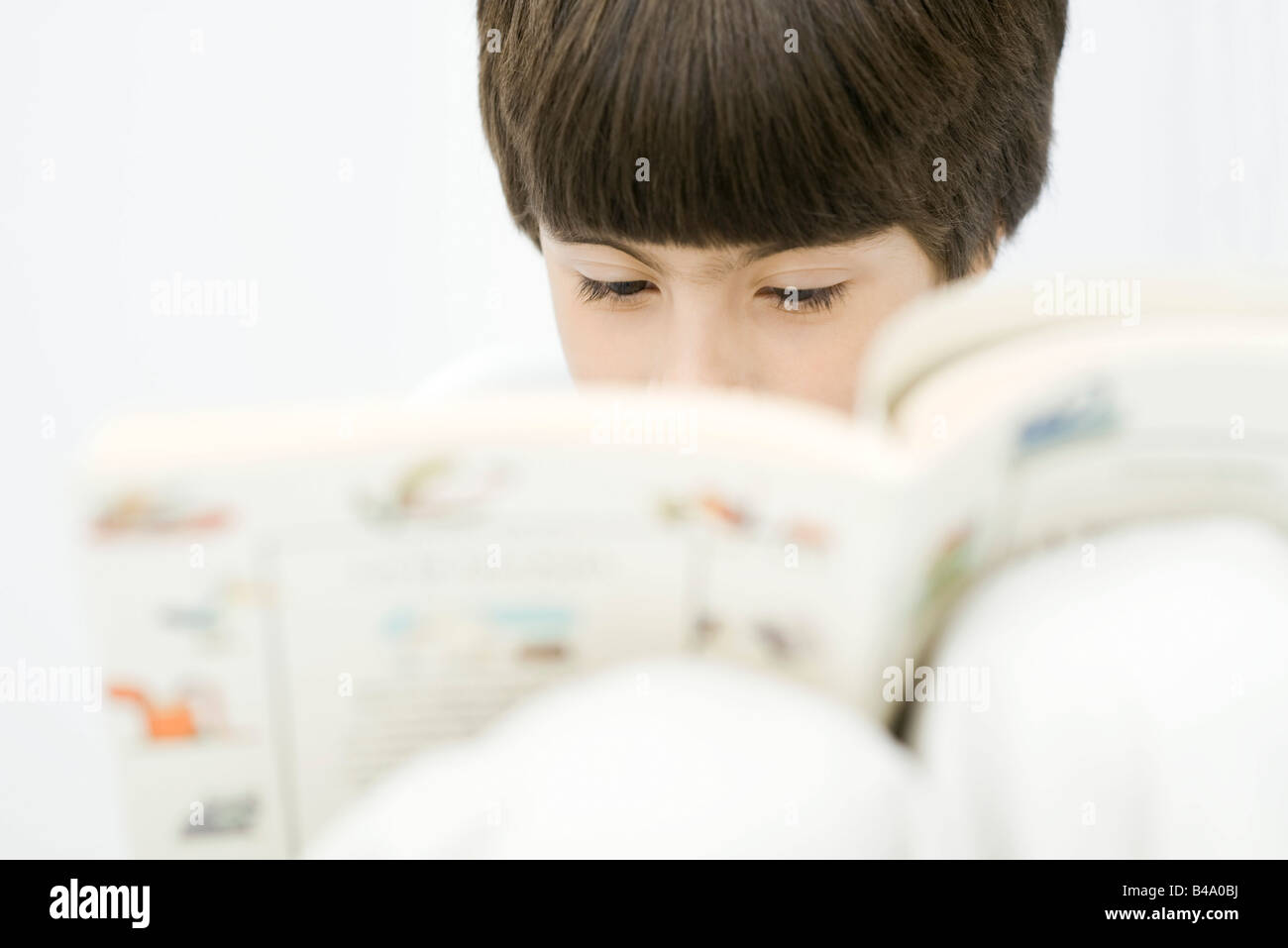 Boy reading book, close-up Stock Photo