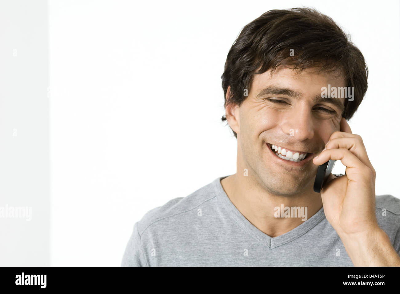 Man using cell phone, laughing, portrait Stock Photo