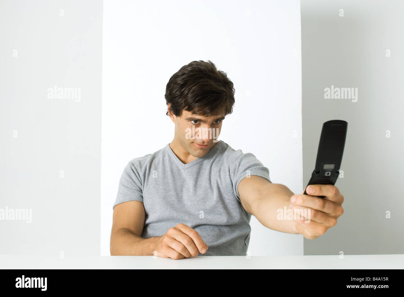Man photographing self with cell phone Stock Photo