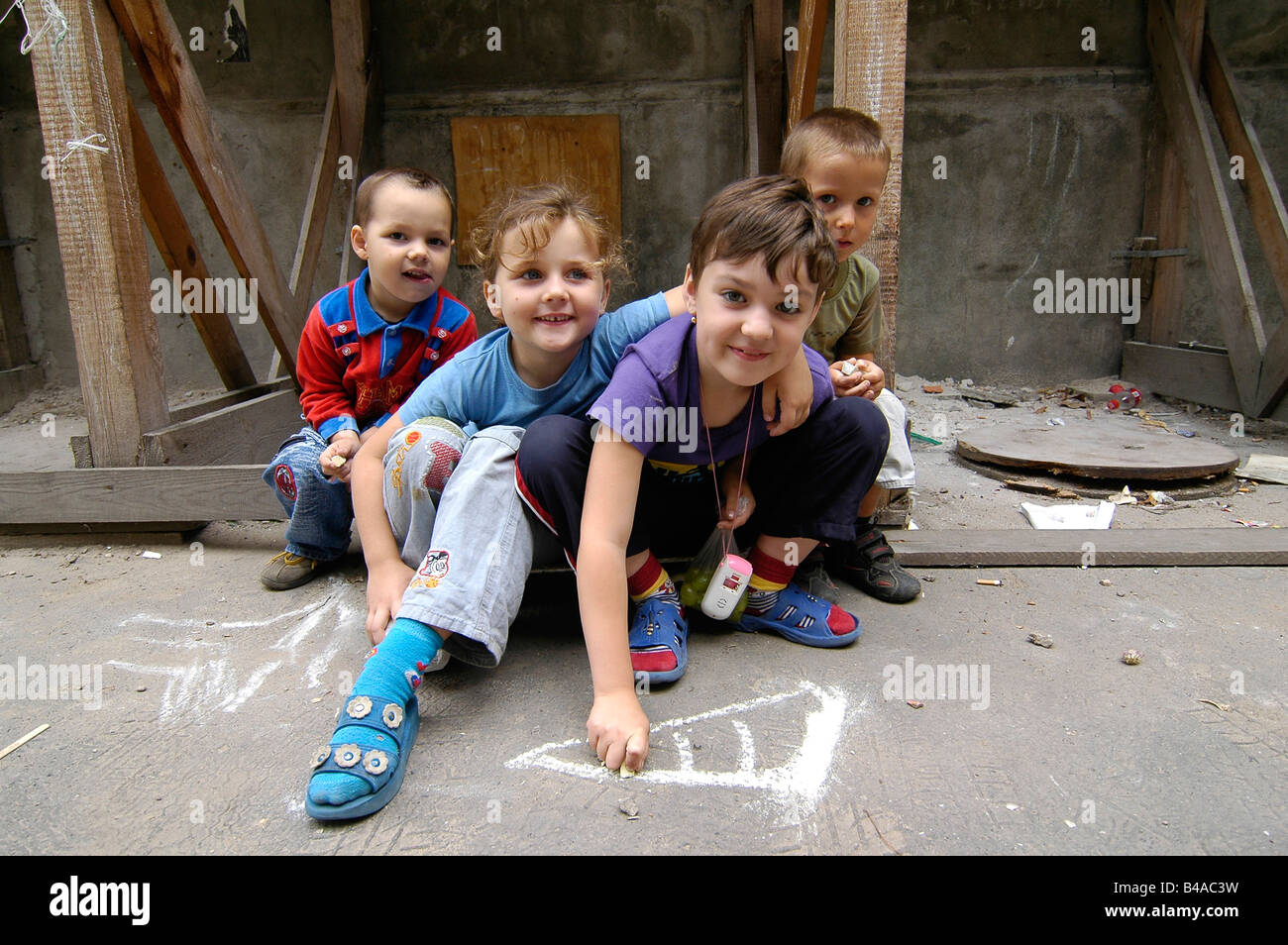 Portrait of Polish kids playing in an old decrepit housing estate in the Stara Praga district of