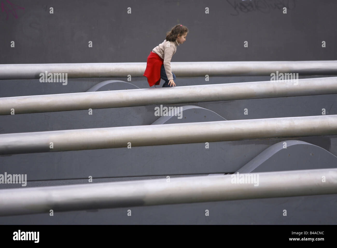 Young girl on Europes longest seesaw in Tilla-Durieux-Park, Berlin, Germany Stock Photo