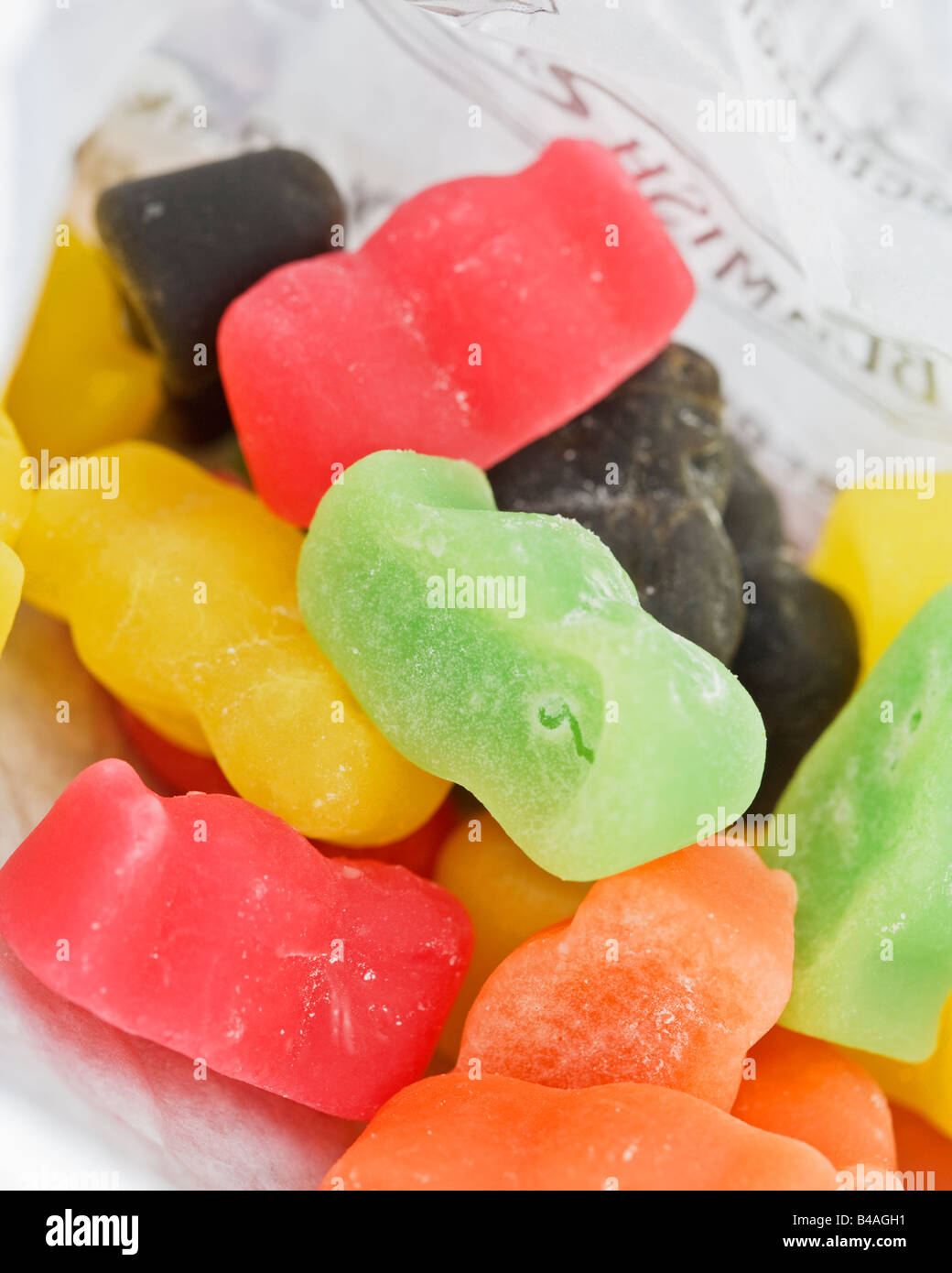 Brightly coloured jelly babies in a white paper bag Stock Photo Alamy