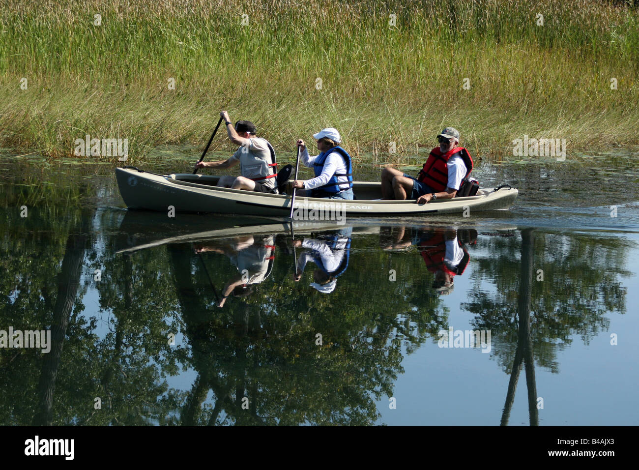 Three people in canoe on Presque Isle, Pennsylvania Stock Photo