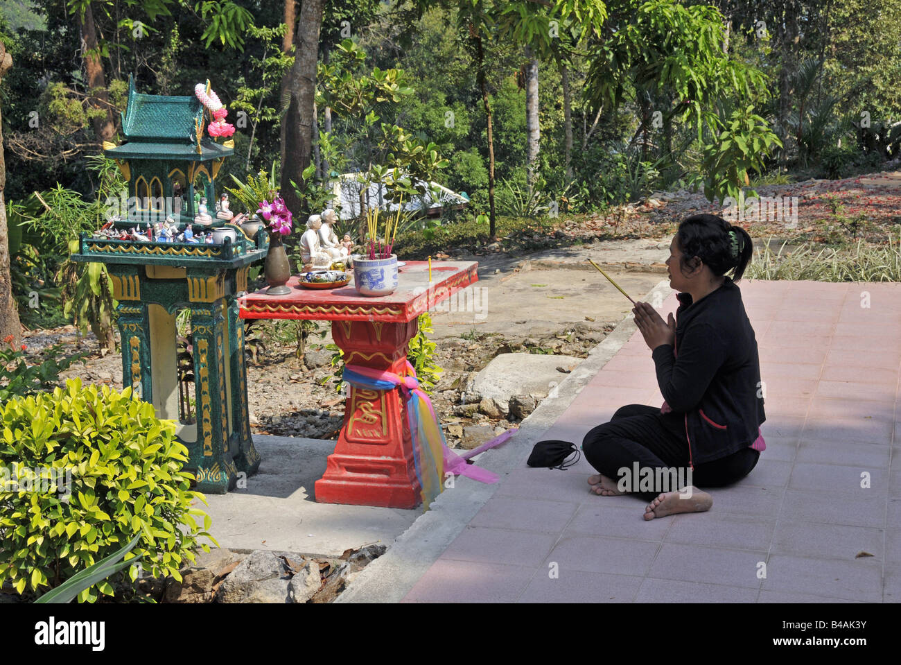 religion, Buddhism, prayer in front of a spirit house, Koh Chang, Thailand, Additional-Rights-Clearance-Info-Not-Available Stock Photo
