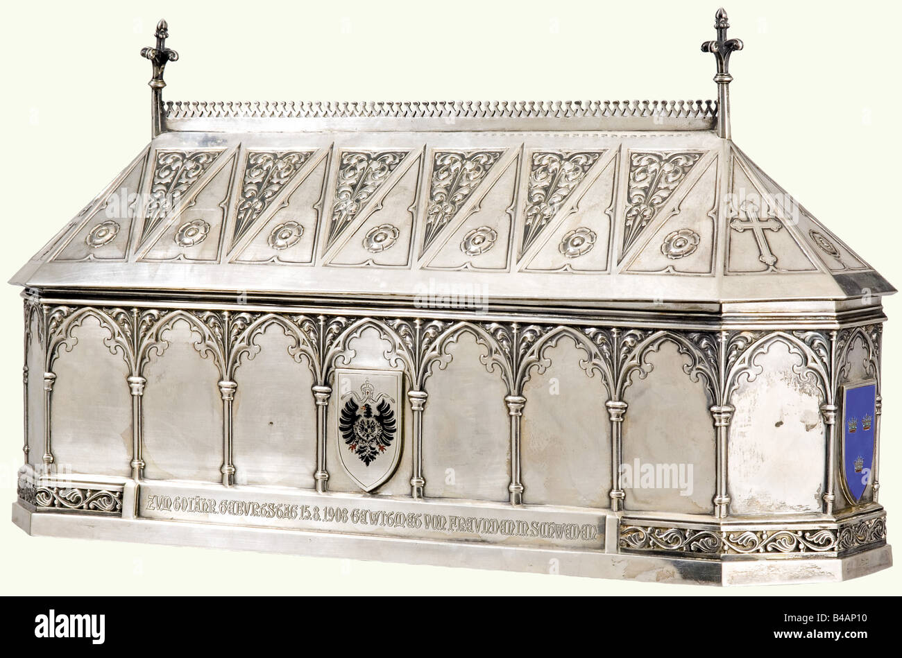 A group for Bishop Albertus Bitter., An elongated octagonal silver sarcophagus case with arch decoration. An enamelled coat of arms of Melle, Sweden, Stockholm and the imperial German eagle are superimposed on the sides. The lower frieze is engraved 'Herrn Bischof Dr. Albertus Bitter zum 60jähr Geburtstag 15.8.1908 gewidmet von Freunden in Schweden (To Bishop Dr. Albertus Bitter on his 60th Birthday from his Friends in Sweden). German and Swedish silver hallmarks. Weight 2360 grams. 38 x 12 x 20 cm. There is also the presentation document on parchment, Artist's Copyright has not to be cleared Stock Photo