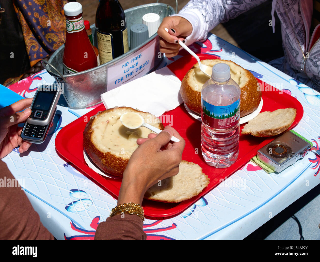 Eating Clam Chowder In Sour Dough Bread, And Making A Phone Call Stock