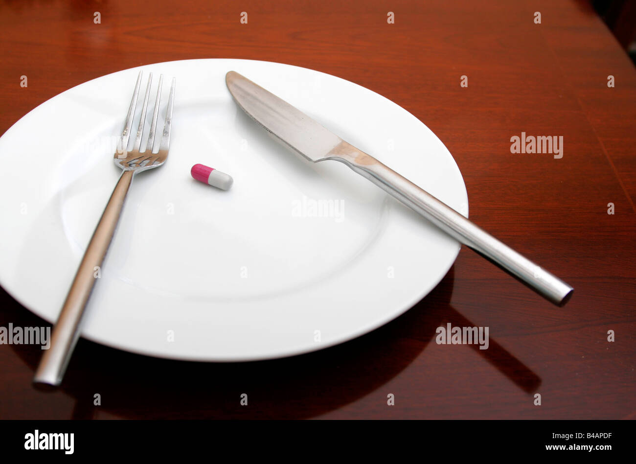 Dinner plate with knife fork and pill Stock Photo Alamy