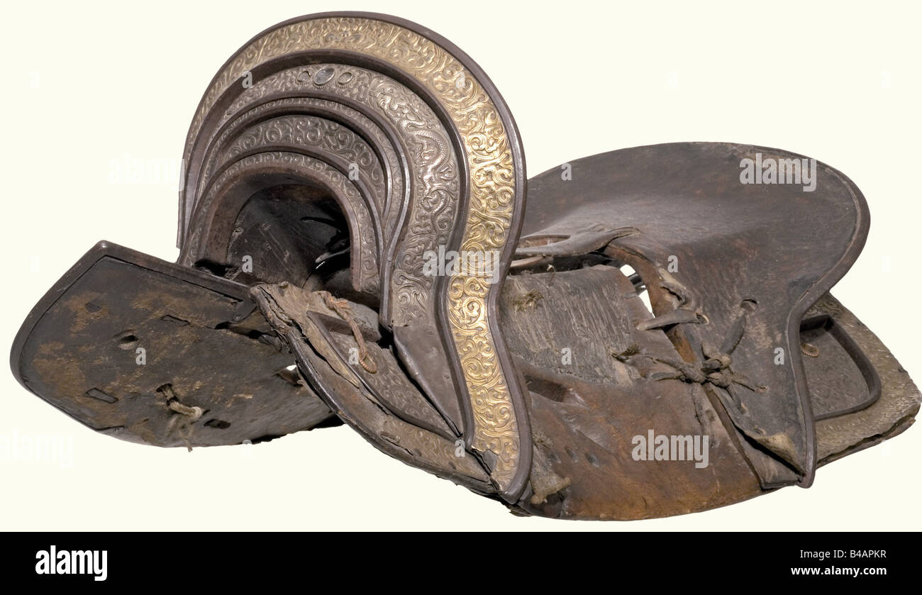 A magnificent saddle, Tibet, 19th century Partially leather covered wooden construction, both cantle and saddletree are mounted with fine relief decoration in silver and brass, a little loose at the left edge. All pieces are tied together with straps and reins. Length 55 cm. historic, historical, 19th century, Far East, Far Eastern, weapon, arms, weapons, arms, military, militaria, clipping, cut out, cut-out, cut-outs, object, objects, stills, Stock Photo