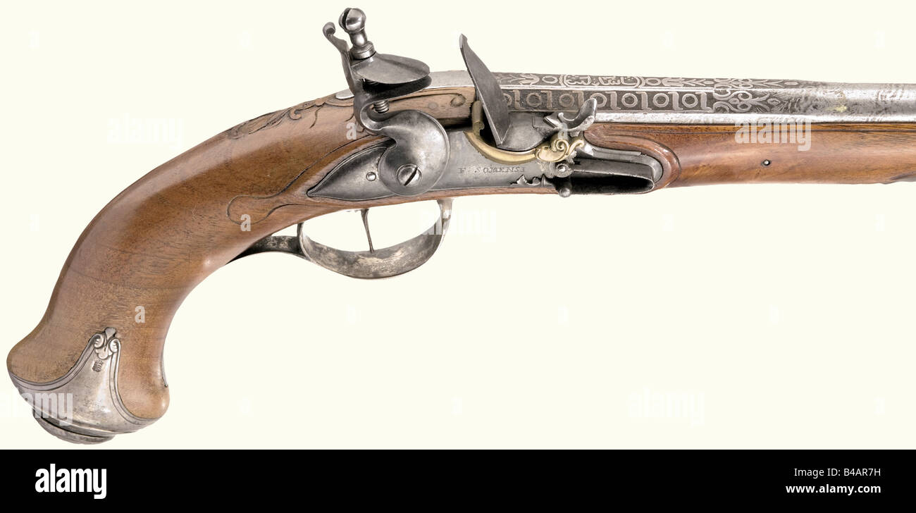 A silver-mounted flintlock pistol, German, circa 1800. Octagonal then round, etched Damascus barrel. Smooth bore in 14 mm calibre. Silver inlay of a pseudo-inscription in Oriental style on the chamber. The flintlock with brass powder pan and frizzen with roller bearing, signed 'F. Somensi' and marked 'SM'. Walnut stock with horn nose cap. Lightly engraved iron furniture stamped 'NB' and with the Saxon coat of arms. Wooden ramrod with horn tip. Length 44 cm. historic, historical, 19th century, civil handgun, civil handguns, handheld, gun, guns, firearm, fire arm, Stock Photo