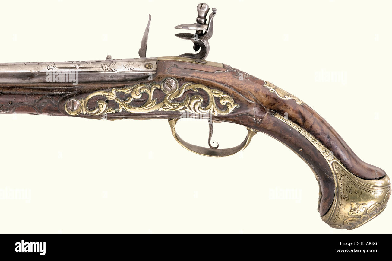 A flintlock pistol, Wolfgang Andreas Weiland, Kassel(?), circa 1730. Round barrel with smooth bore in 15 mm calibre with barrel rib. There are four brass filled marks 'DT' (Stöckel No. 1085 and 5971) inscribed at the breech for Daniel Thiermay, Paris ca. 1700 - 40. Flintlock engraved with the signature 'Wolfgang Andreas Weiland'. Carved walnut stock with bronze furniture engraved and chiselled in relief. Replacement ramrod. Length 50 cm. historic, historical, 18th century, civil handgun, civil handguns, handheld, gun, guns, firearm, fire arm, firearms, fire arm, Stock Photo