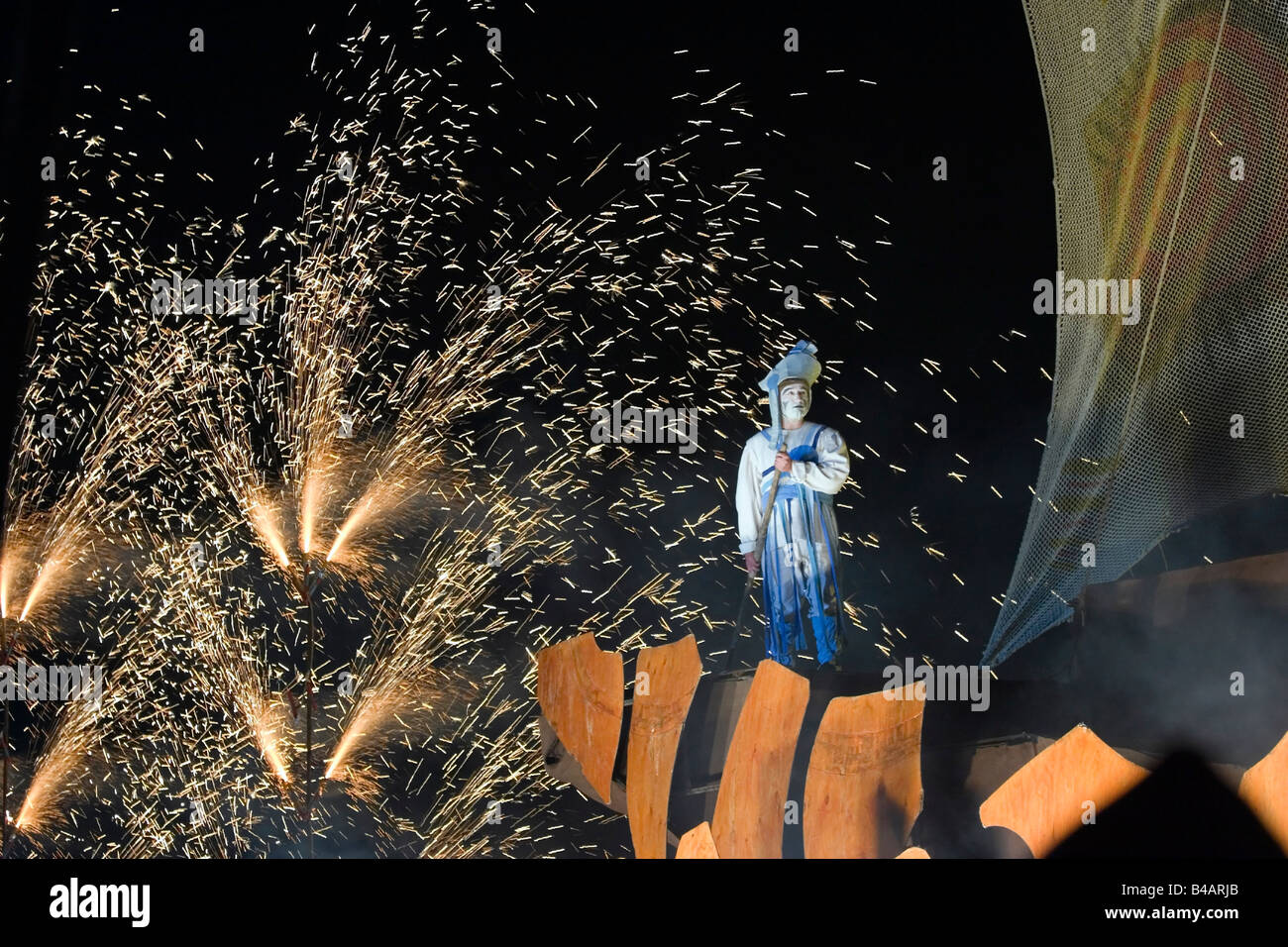 An actor from the Spanish Xarxa teatre in front of fireworks at the Cultural Olympiad event in Weymouth organised by Inside Out Stock Photo