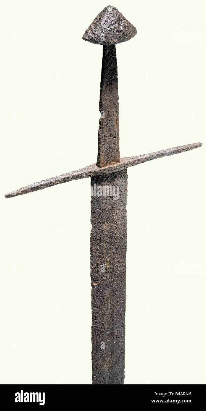 A German knightly sword, 12th/13th centuries. Heavy, double-edged blade with fullers on both sides. The point has been damaged by corrosion. There is a coat of arms inlaid in brass on one side, the opposite side has an inlaid 'Wolfsangel' rune. Wide spread quillons with a quadrangular cross section tapering slightly at the ends. Heavy tang with a flattened conical (Oakeshot, Type E). Cleaned excavation discovery. Length 109 cm. historic, historical, 13th century, 12th century, sword, swords, weapons, arms, weapon, arm, fighting device, military, militaria, obje, Stock Photo