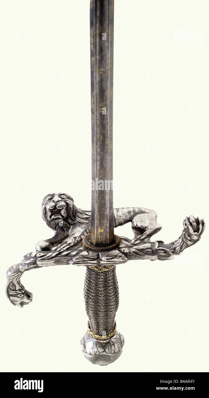 A chiselled iron rapier, school of Gottfried Leygebe, Berlin, circa 1660. Slender thrusting blade of flattened hexagonal section and fullers on both sides at the base of the blade. The upper third of the blade shows engraved gilded decoration on a blued background. Inscribed 'EN TOLEDO' in the fullers. Richly cut grip. S-shaped quillons with monster head finials. The guard plate is in the shape of a sculpted lion. Grip cover with lavish brass wire winding and braided ferrules. Chiselled iron pommel. Length 95 cm. historic, historical, 17th century, sword, sword, Stock Photo