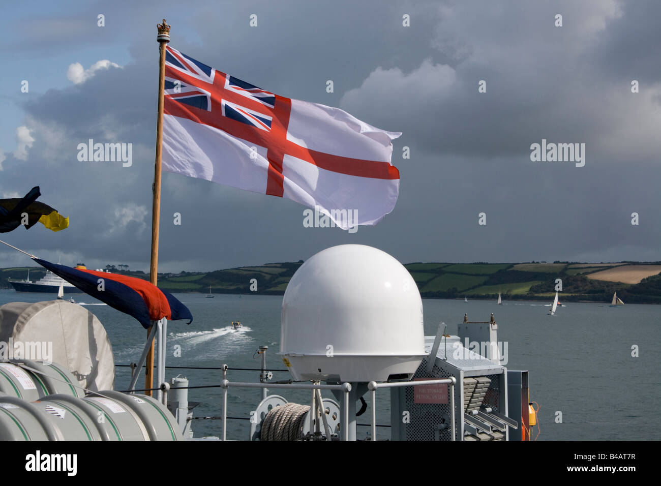 White Ensign flag flying on stern of Royal Navy mine sweeper Falmouth Cornwall UK Stock Photo