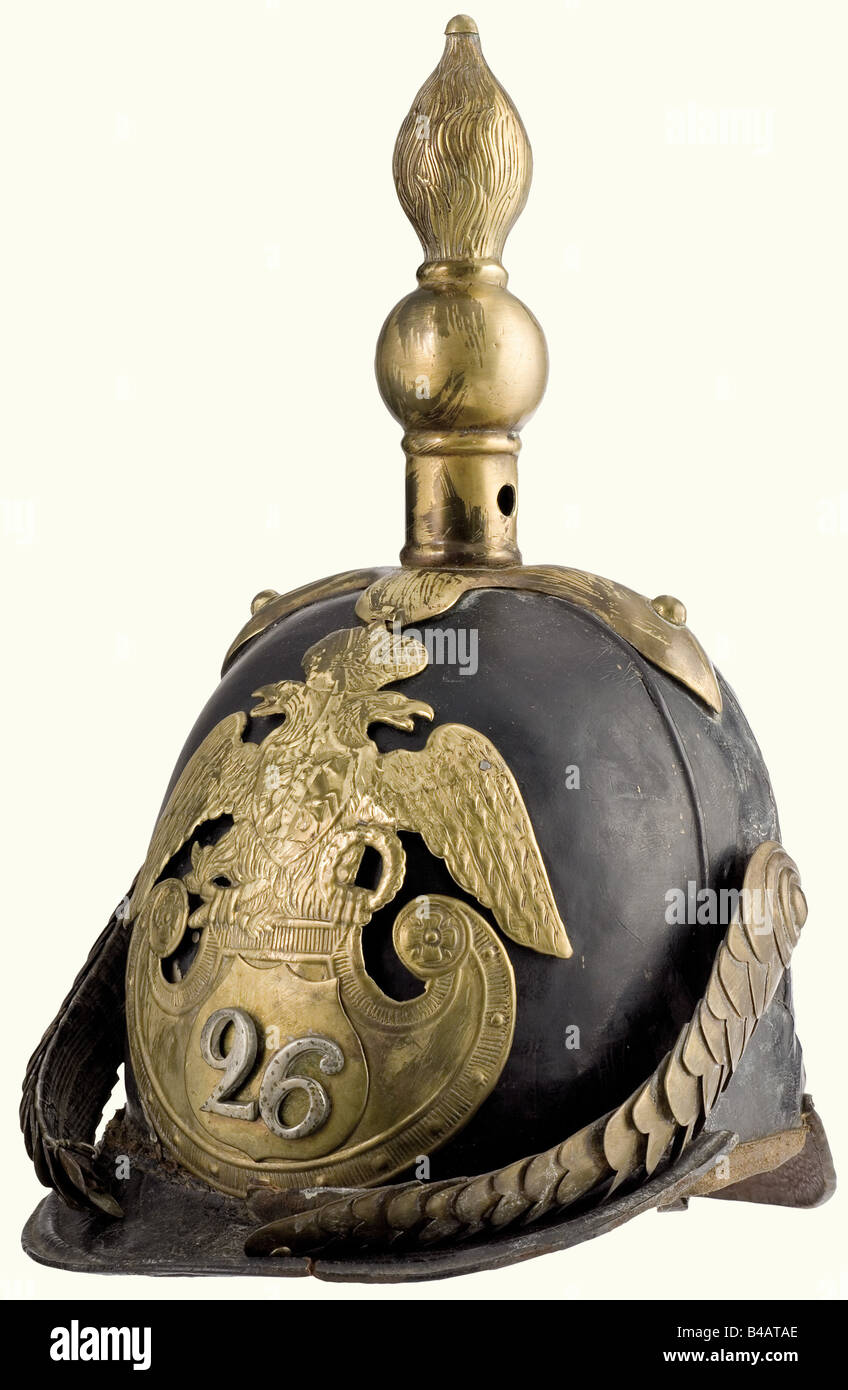 A model 1844 helmet for enlisted personnel, of the 26th Infantry Regiment of the Line. Leather skull with leather lining and brass mountings. The shield with the coat of arms was transferred at the time from a 69th Regiment shako. Chinscales are damaged. Cockade missing. The peak sewing is undone in places, a crack in the front peak. Interesting helmet from the period of the Crimean War. Easily restorable. historic, historical, 19th century, defensive arms, weapon, weapons, protective, protection, metal, armour suit, armor suit, suit of armour, piece, pieces, u, Stock Photo