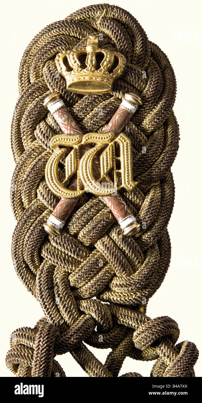 Kaiser Wilhelm II - an aiguillette for his Grand Admiral's uniform., A shoulder knot woven from twisted gold cord, divided into two woven strands, which terminate in crowned golden points. Superimposed with two crossed, gilded Grand Admiral's batons, enamelled red, and white, and with the crowned cipher 'W' on top, the insignia of an aide-de-camp to his grandfather, Wilhelm I. The gilding on the cord and the weave is somewhat worn and darkened. Dark blue cloth backing with two pins and a button-on attachment flap. At the request of the Imperial Navy, Wilhelm II, Stock Photo