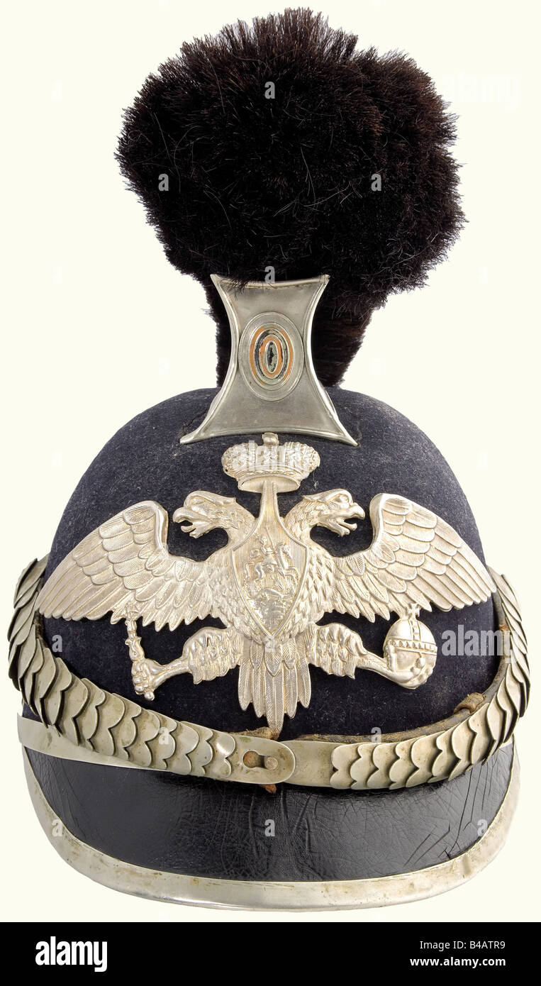 A helmet for the Special Corps, of the Regional, Fortress, Divisional, and Railroad Gendarmerie, from 1911. Felt skull, leather front peak, silver-coloured comb (old repair to the rear extension) with a horsehair crest, leather backed metal chinscales, rosettes with the tsarist double eagle. Superimposed, silver-plated double eagle. Leather sweatband. Slightly restored after the period worn. historic, historical, 1910s, 20th century, object, objects, stills, clipping, clippings, cut out, cut-out, cut-outs, helmet, helmets, headpiece, headpieces, utensil, piece , Stock Photo